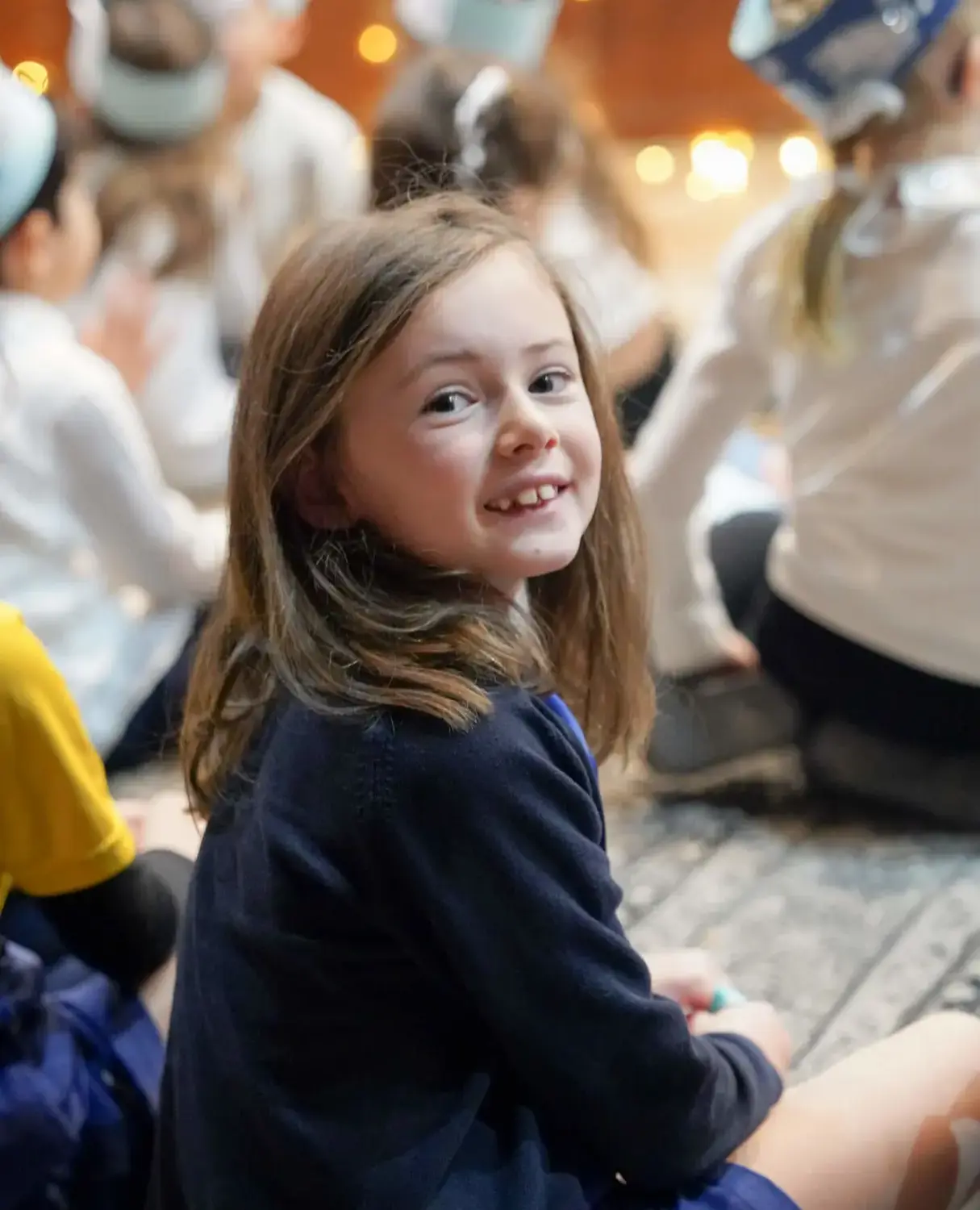 BISR Al Hamra student smiling while listening in a lesson.