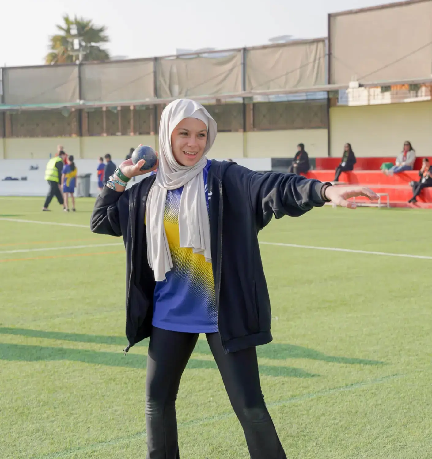 BISR Al Hamra student about to throw a Shot Put in a sports lesson.
