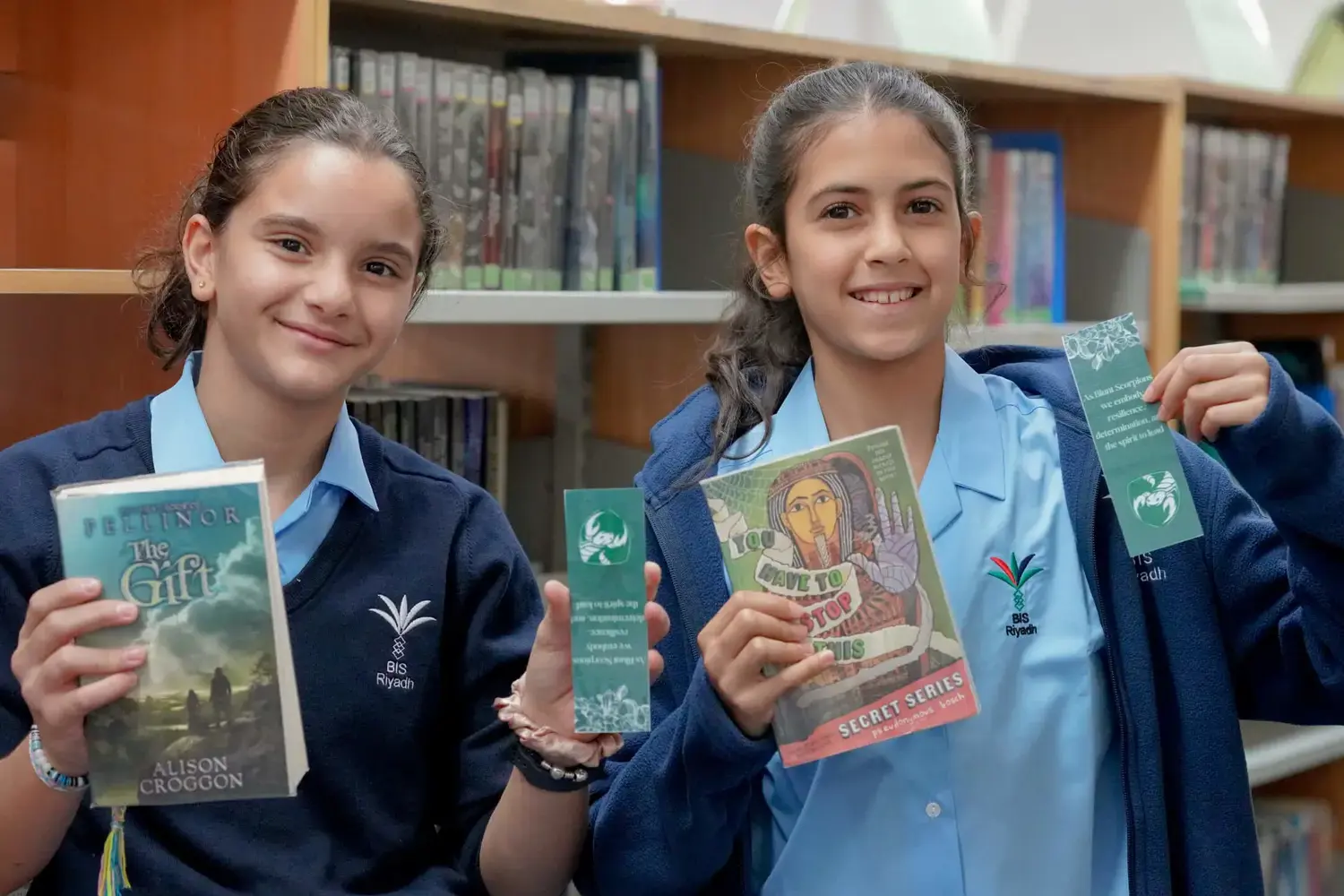 BISR Al Hamra students pose for a photograph with their books in the library.
