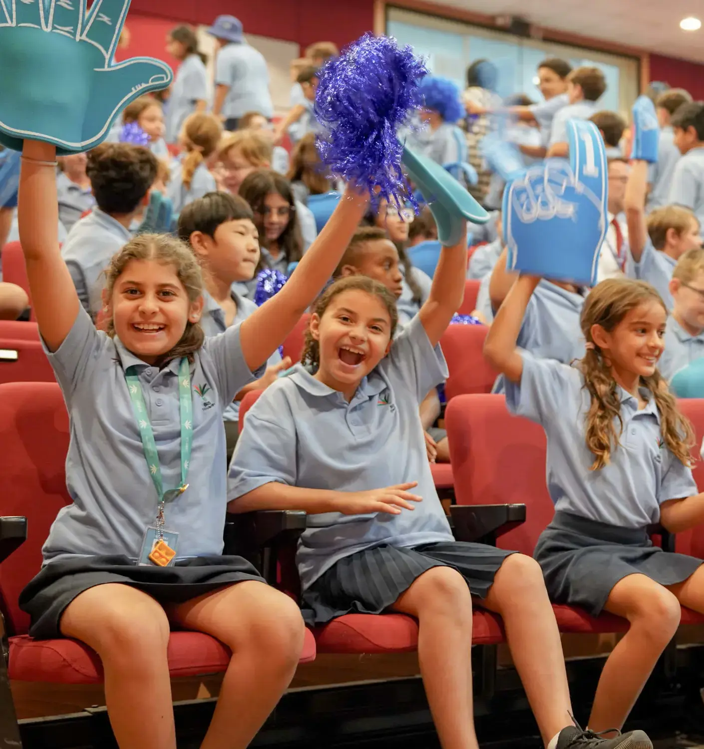 BISR Al Hamra students cheering at a school event.