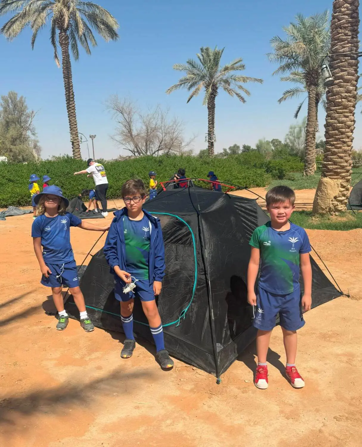 BISR students stand in front of their tent during a trip to the farm.