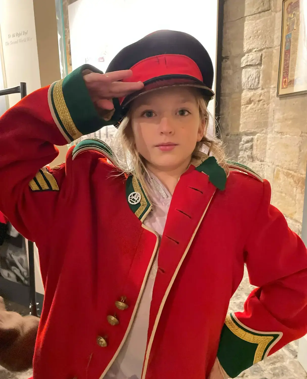 BSR salutes the camera while wearing a red jacket during a school trip to Plas Menai.