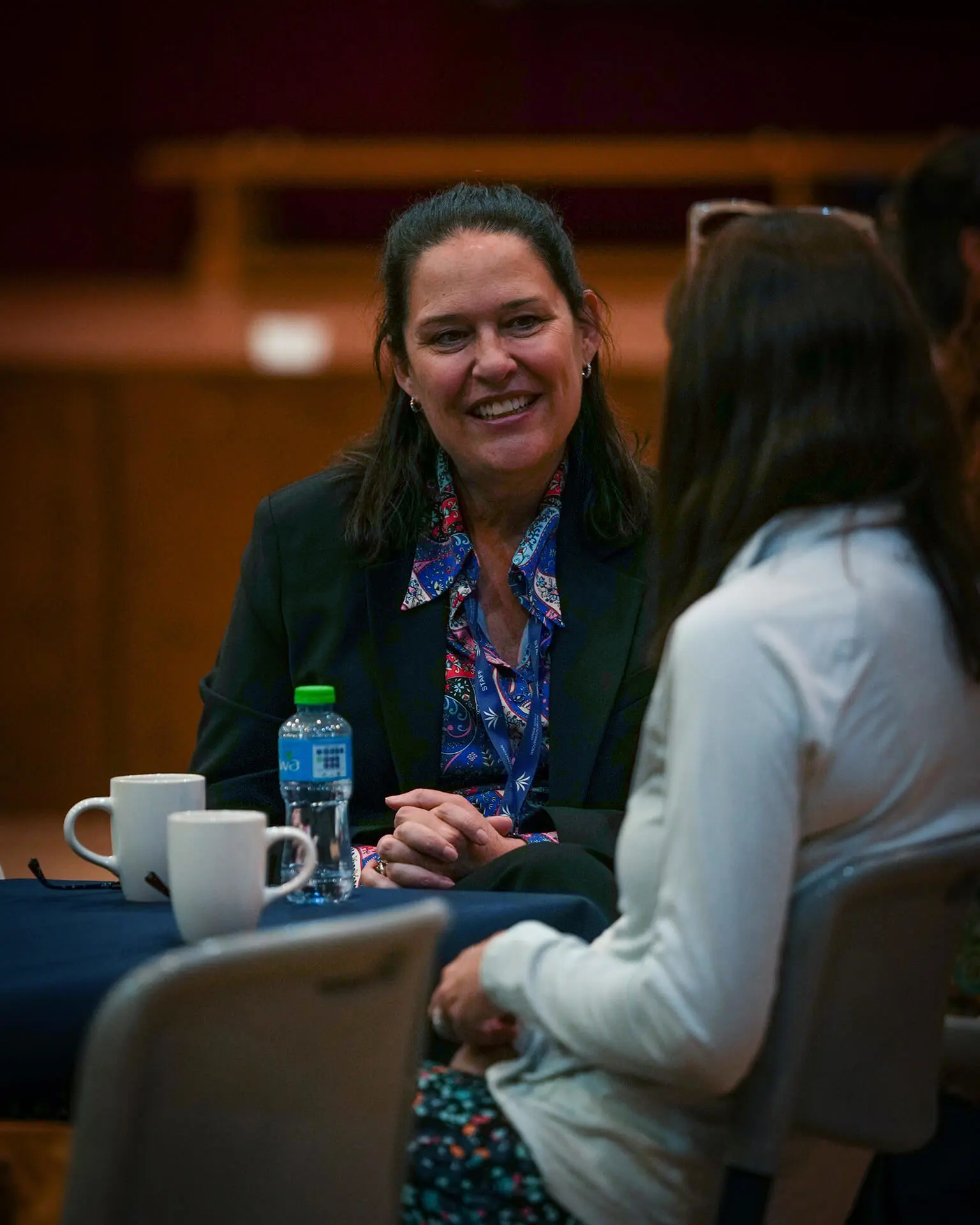 Two parents having a conversation at a coffee meeting at British International School Riyadh, the best British curriculum school in Saudi Arabia