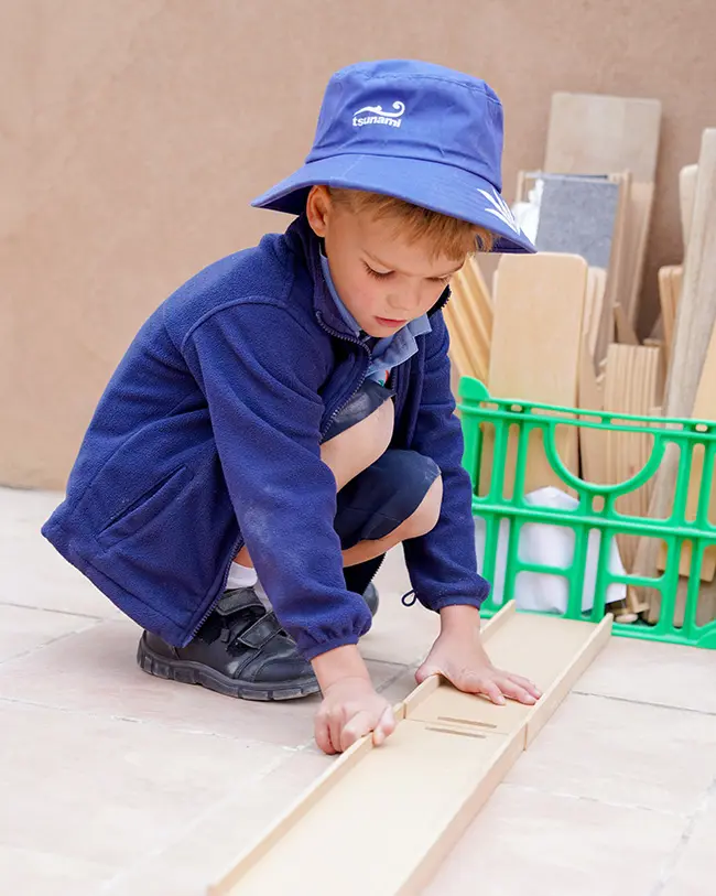 Boy playing with wood