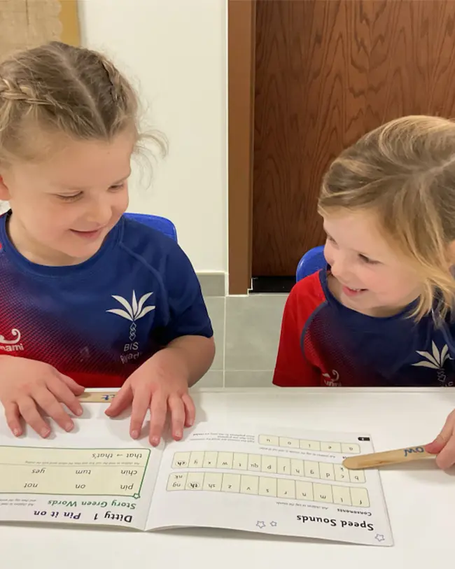 Girls learning phonics at BISR